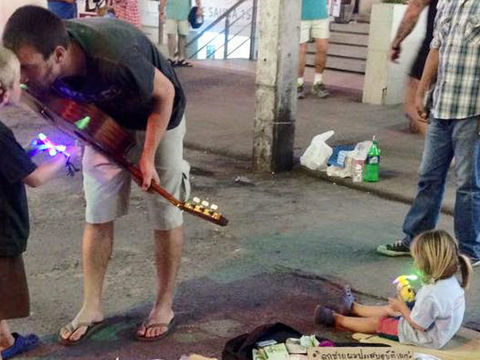 Dad goes busking to collect cash for daughter hurt in Phuket